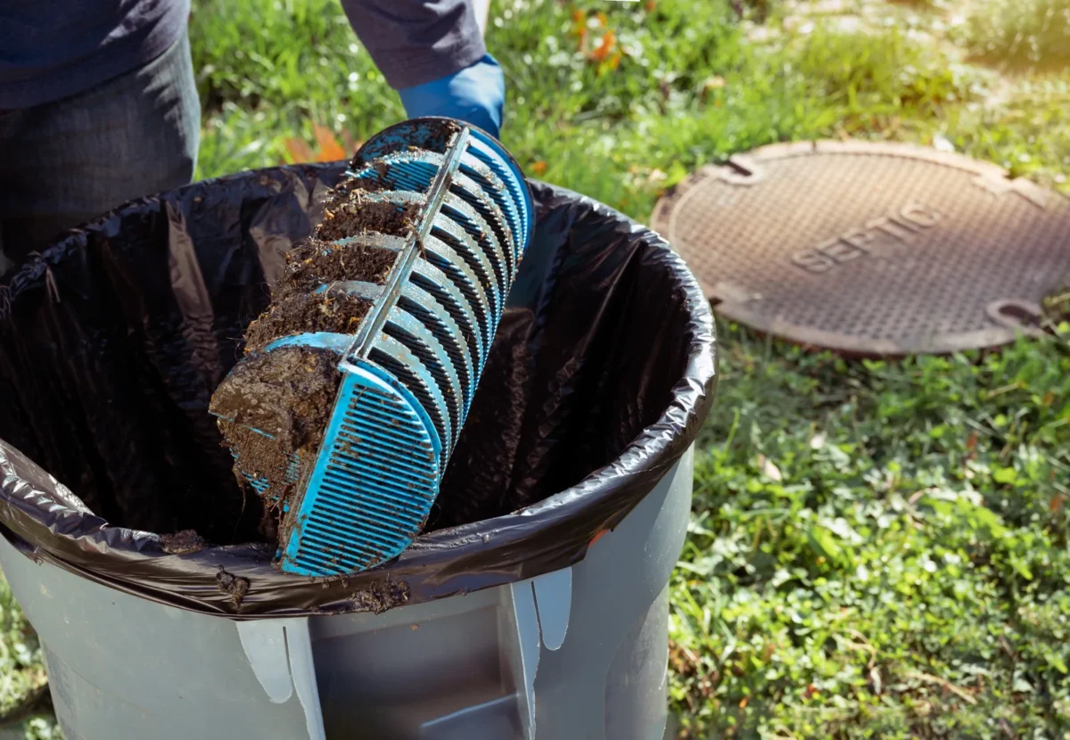 Operative examining a fouled Tuf-Tite septic tank outlet filter